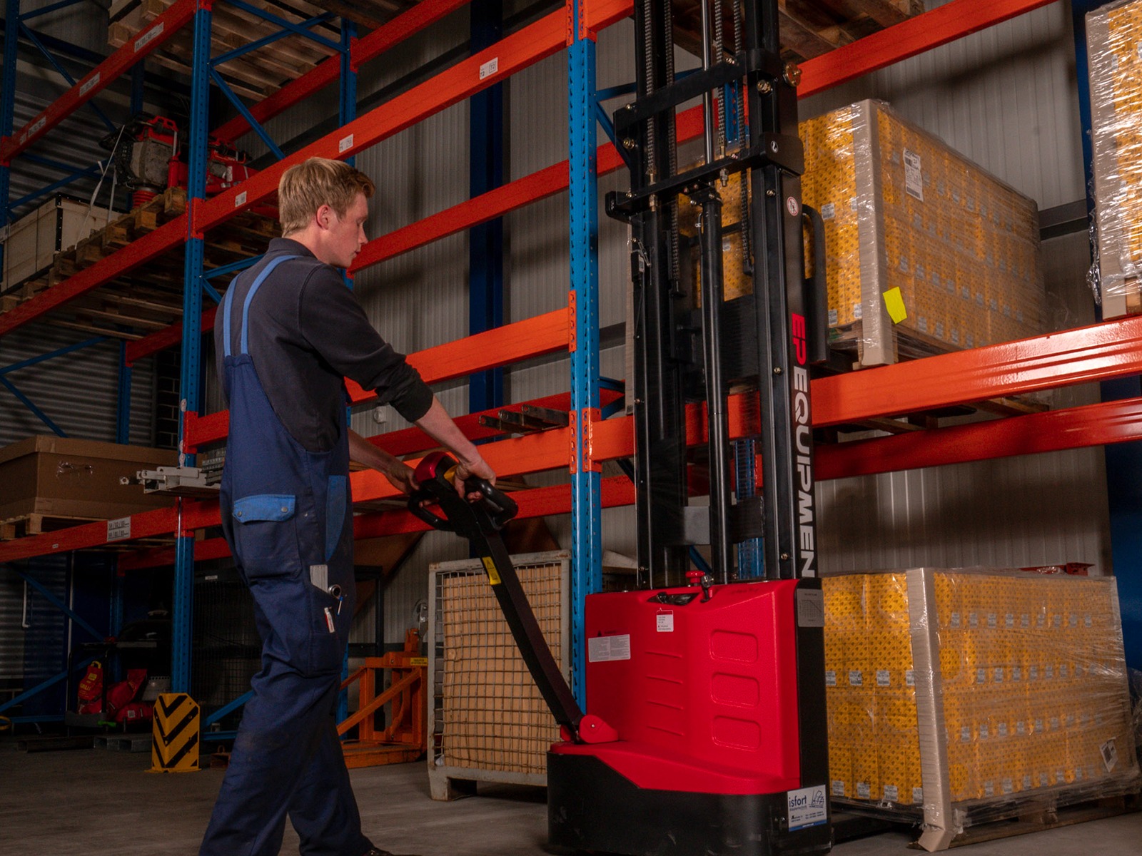 ES-ES SERIES electric pallet stacker being used to retrive loads in a warehouse.